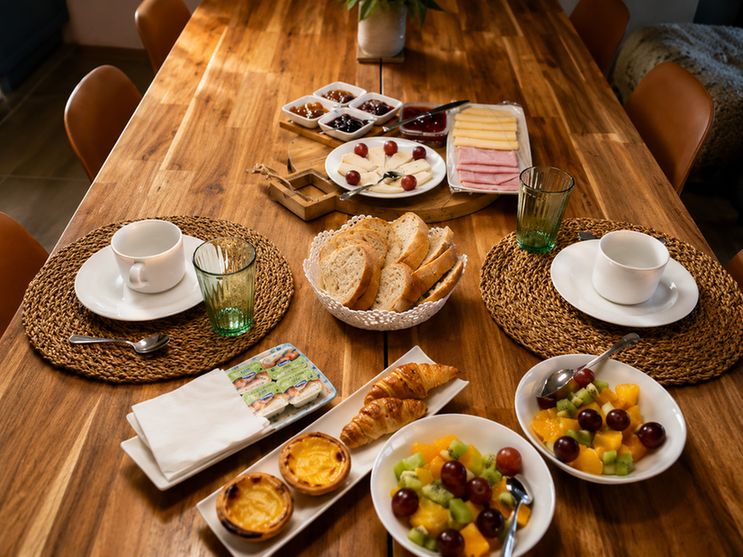Um pequeno-almoço continental com pão local, queijos e compotas